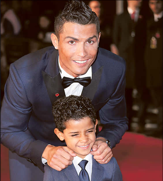 Cristiano Ronaldo smilende med barn på arrangement Bakgrunner