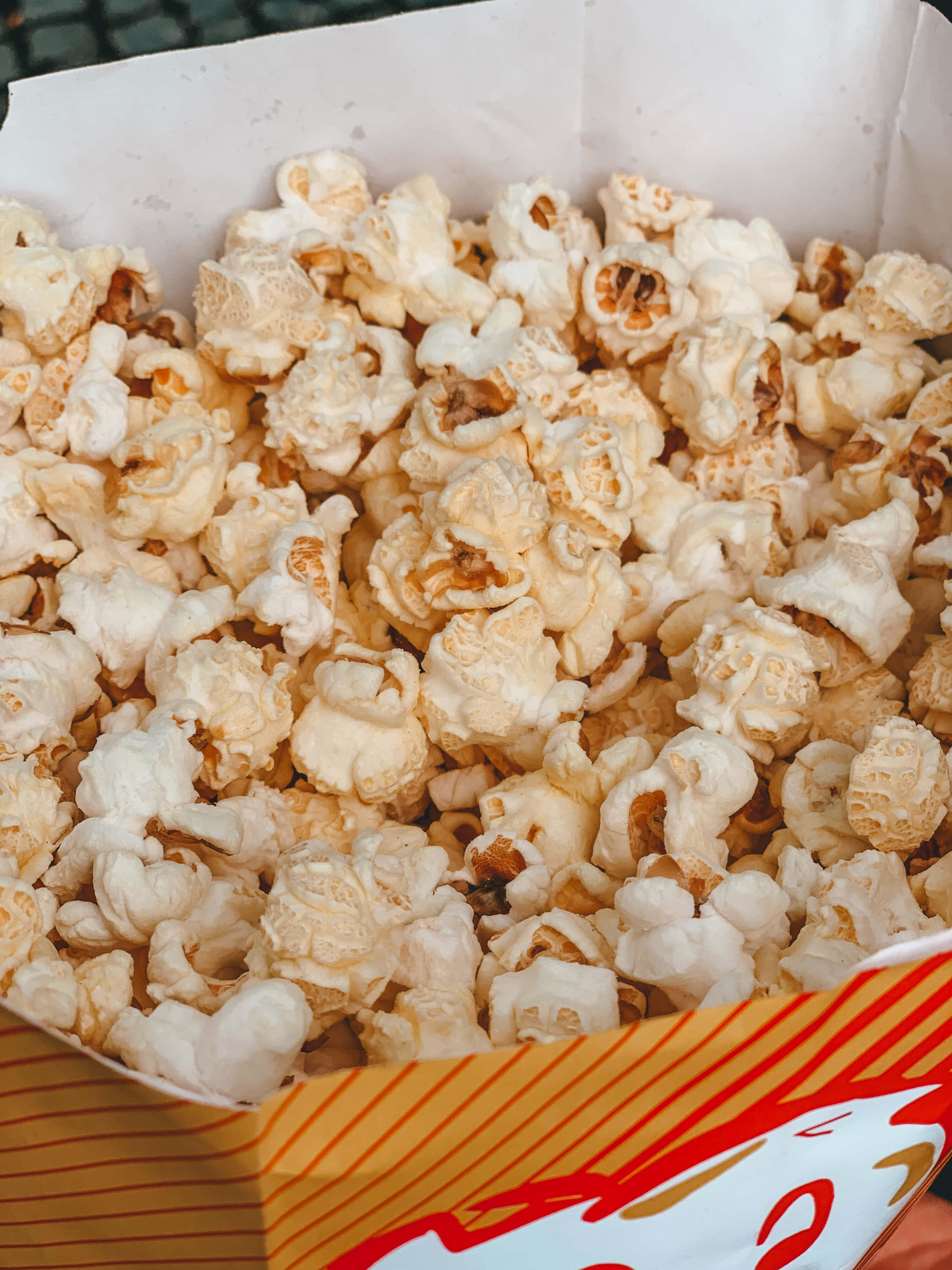 en person som holder en eske med popcorn Bakgrunner