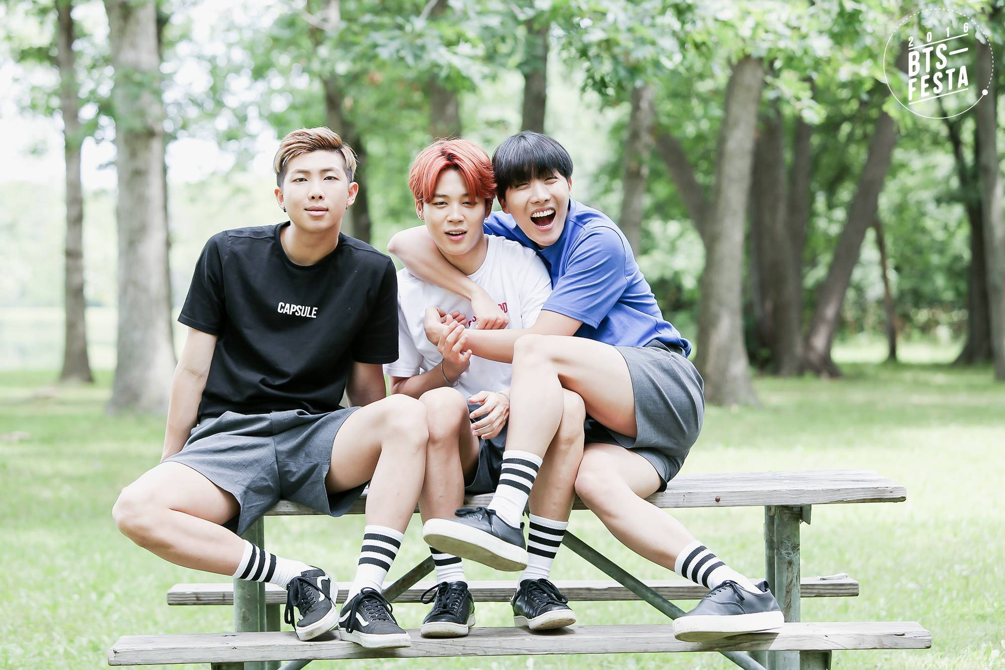 Estetisk BTS-trio på parkbenk Bakgrunner