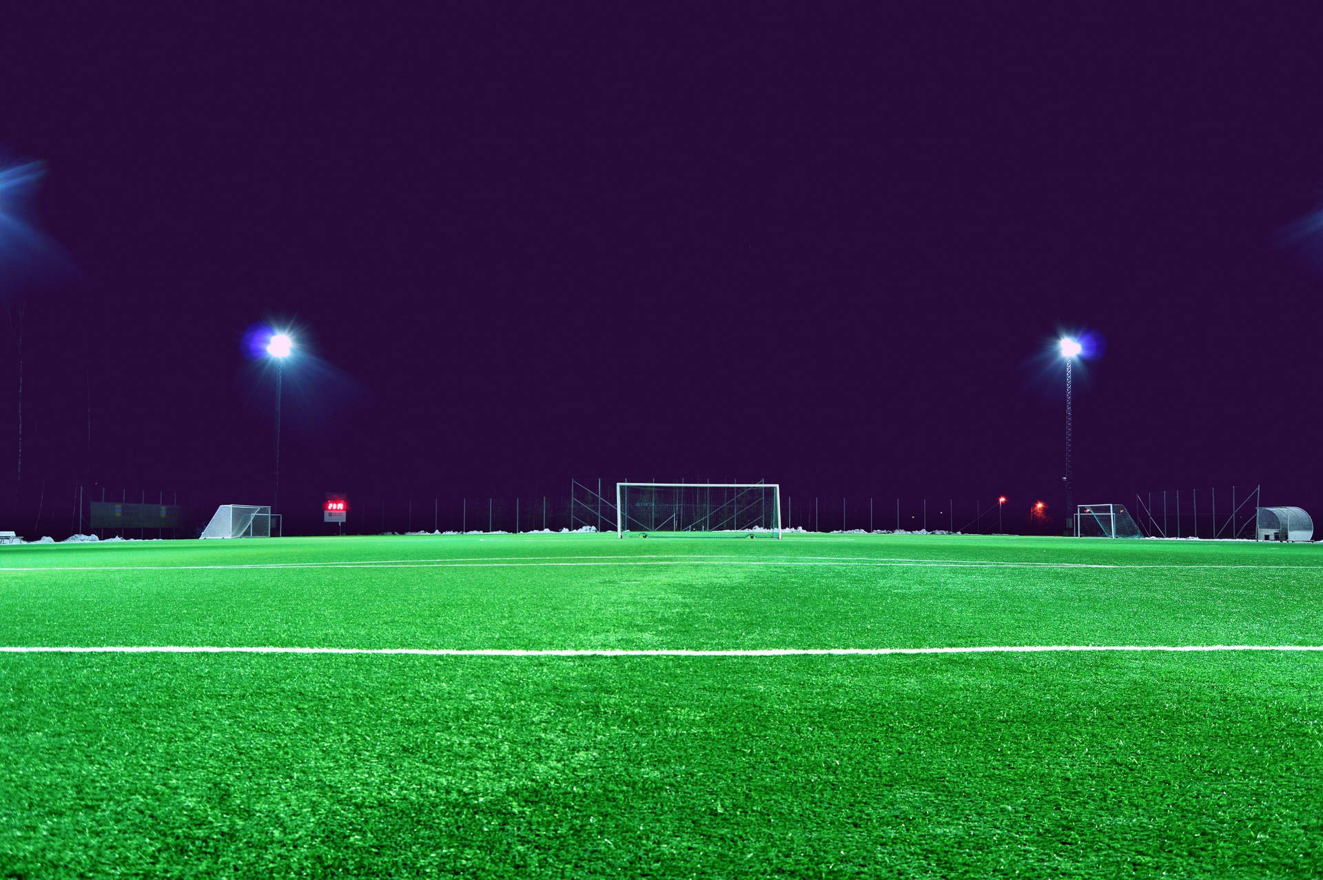 Fotballstadion om natten med mørk himmel bakgrunnsbilde.