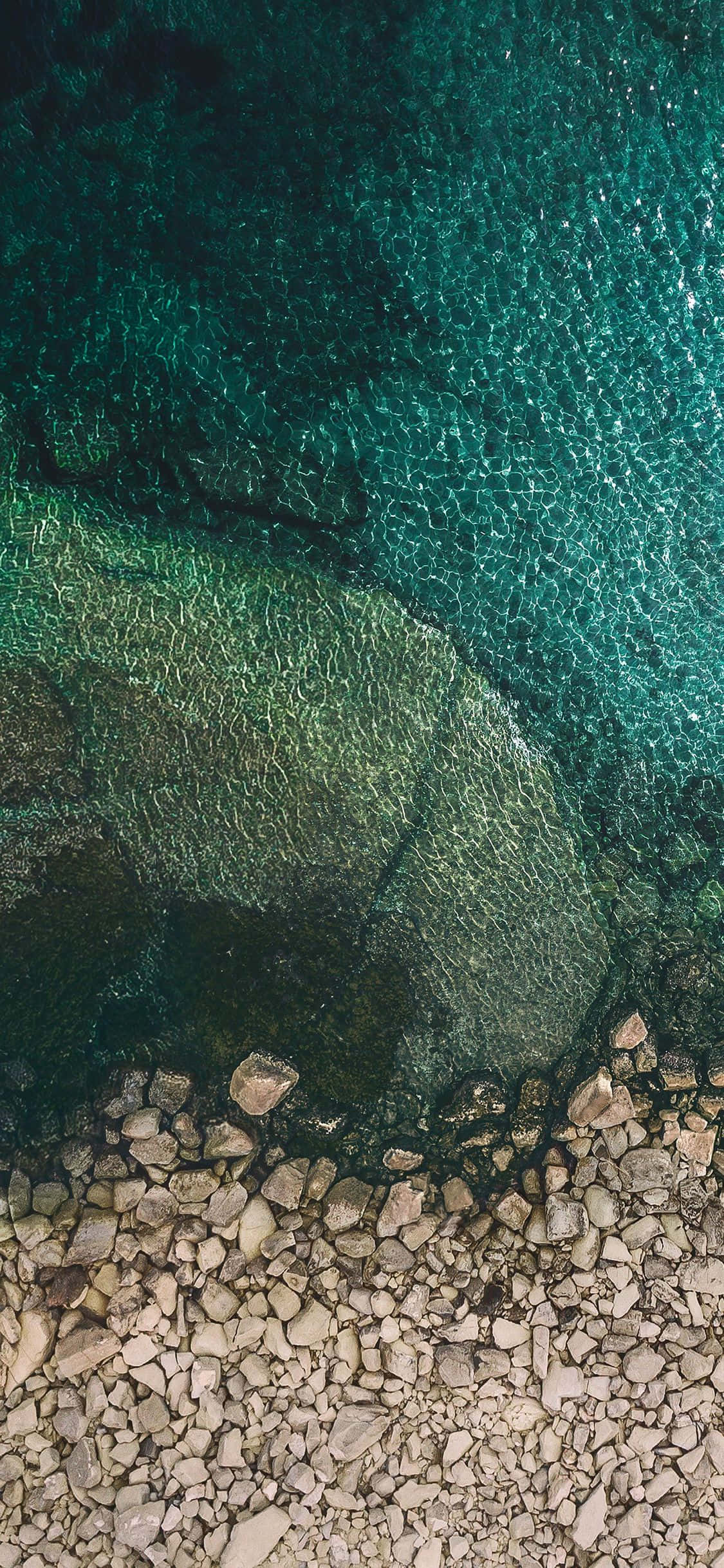 iOS 1 Steinete Strandkant Bakgrunner