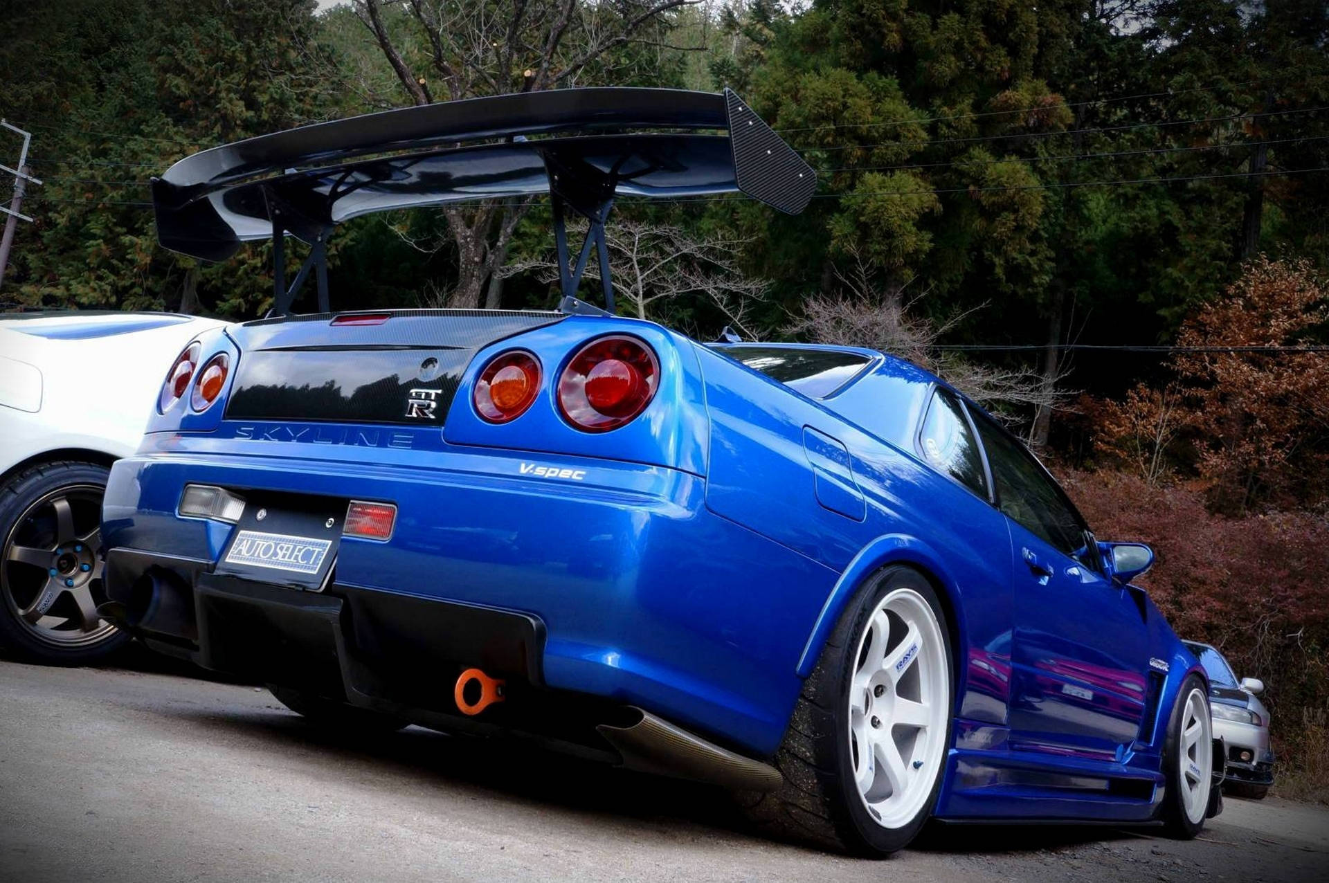 Majestetisk bilde av en Nissan Skyline GTR R34 i høyoppløsning. Bakgrunner