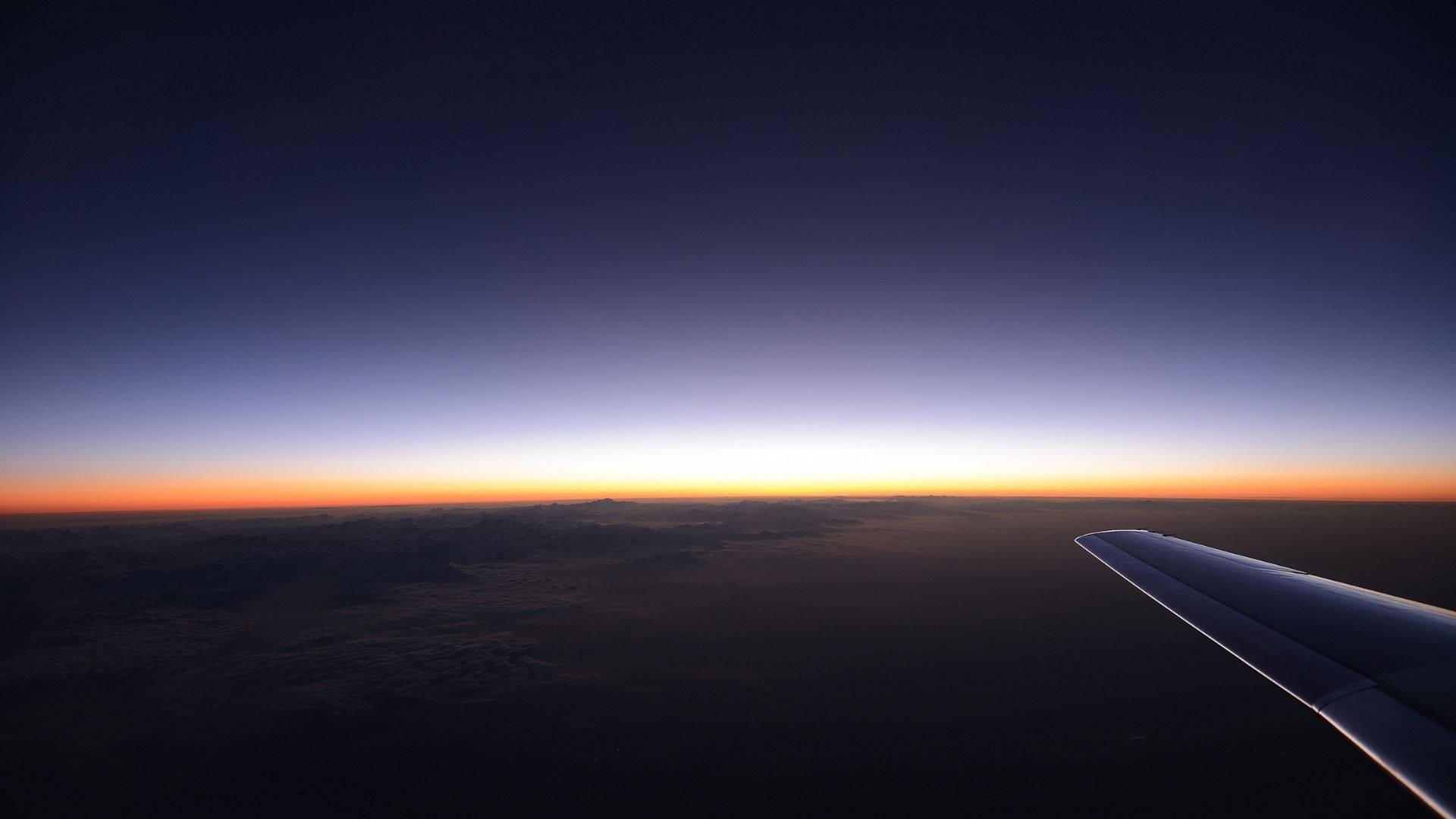 Solnedgangshimmel sett fra fly Bakgrunner