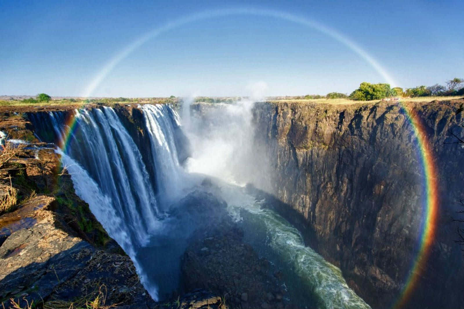 Victoria Falls med en regnbueglorie Bakgrunner