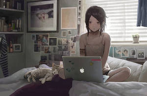 Animejente som jobber med laptop på sengen