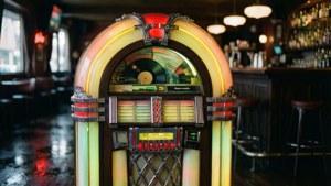 En neonopplyst jukeboks i en stemningsfull retrobar.