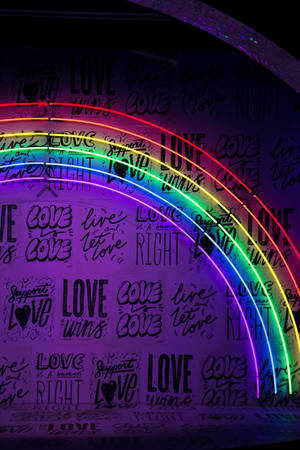 Kjærlighet er kjærlighet neonlys pride-regnbue bakgrunnsbilde