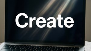 En minimalistisk MacBook-bakgrunn med ordet «Create» i fet skrift.