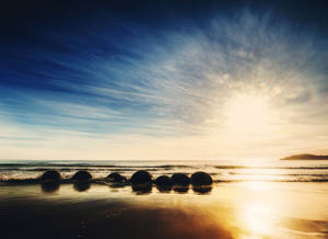 Moeraki Boulders-strand soloppgang bakgrunnsbilde
