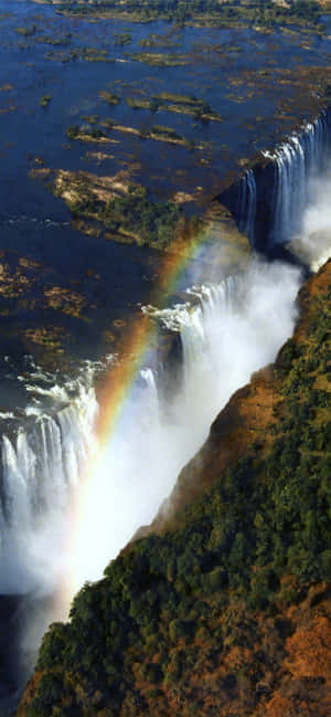 Victoria Falls med en regnbue — Vivo V70 Lite Bakgrunner